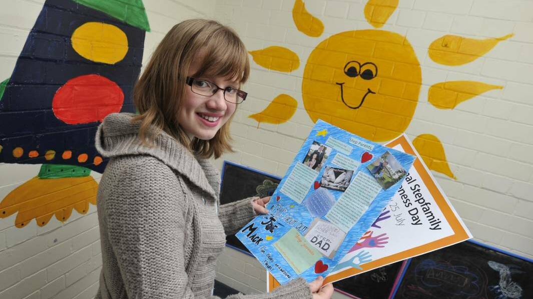 Holly Mack, 12, with the poster she created as a tribute to her stepfather, Joe, for National Stepfamily Awarness Day. Picture: Les Smith