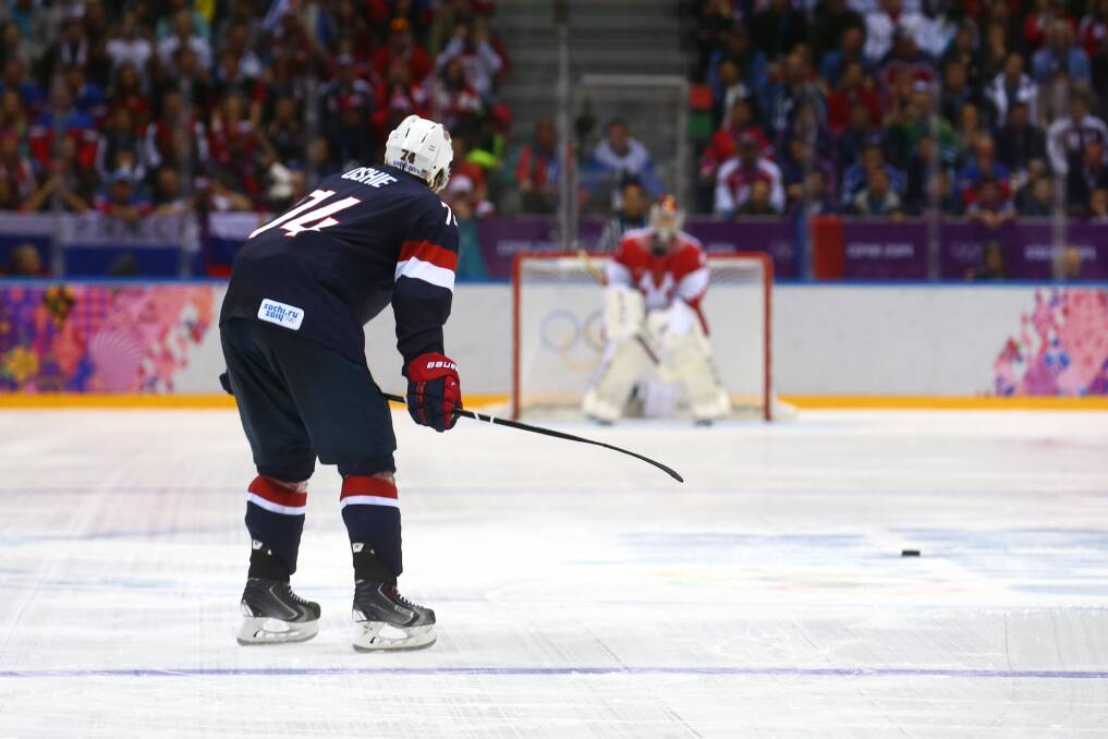 T.J. Oshie #74 of the United States scores on a shootout against Sergei Bobrovski #72 of Russia during the Men's Ice Hockey Preliminary Round Group A game on day eight of the Sochi 2014 Winter Olympics at Bolshoy Ice Dome on February 15, 2014 in Sochi, Russia. Photo: GETTY IMAGES