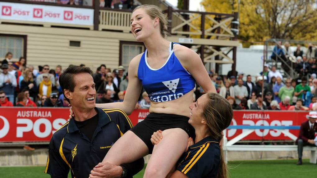 STAWELL: Holly Dobbyn wins the 2014 Womens Stawell Gift, on the shoulders of Peter O'Dwyer and Tara Domaschenz.

