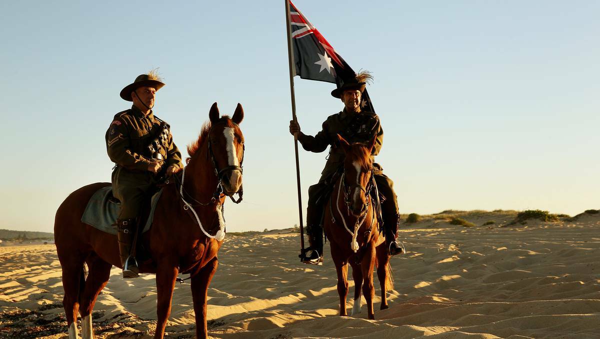 SWANSEA: THE legacy of the light horse units was honoured in Swansea, with a re-enactment of one of Australian military history’s most iconic images. Justin Rumore and Sam Dhnaram in a light-horse re-enactment on Blacksmiths beach. Photo: NEWCASTLE HERALD.