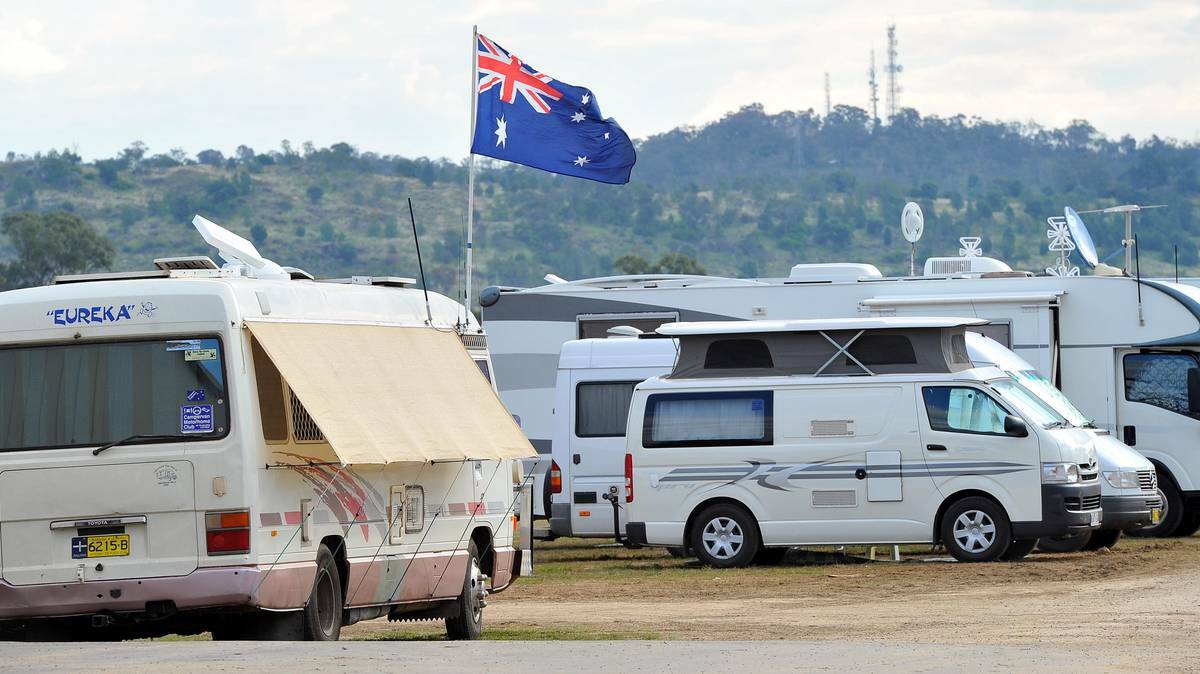 WAGGA WAGGA: An Australian flag flutters in the breeze as Willans Hill backdrops the many vehicles camped at the Stone the Crows Festival in Wagga on Good Friday. Photo: KIEREN L TILLY.
