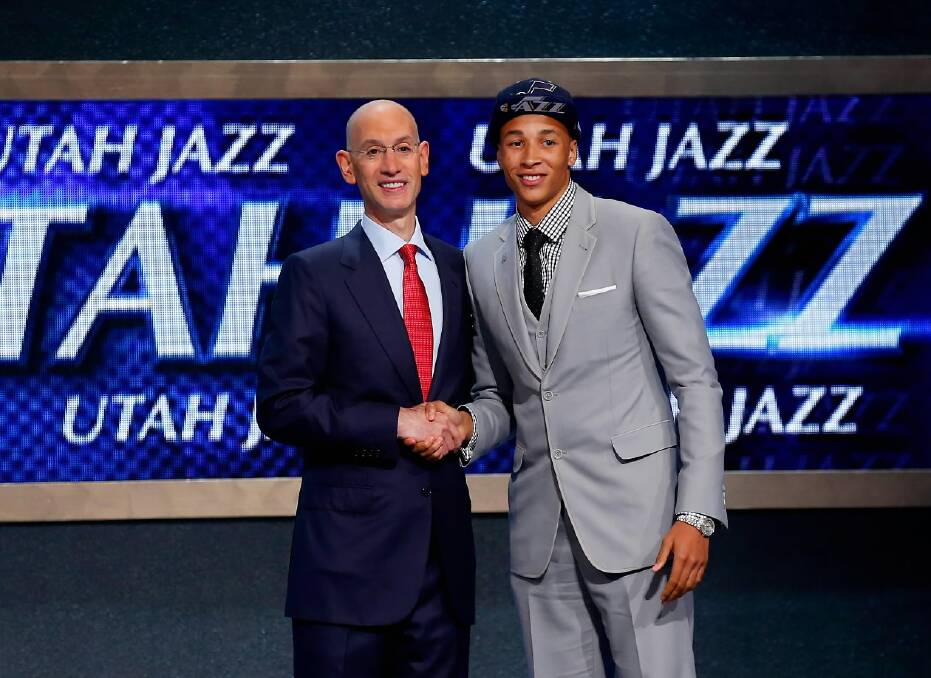Dante Exum (R) shakes hands with NBA Commissioner Adam Silver after being selected with the #5 overall by the Utah Jazz. Picture: GETTY IMAGES