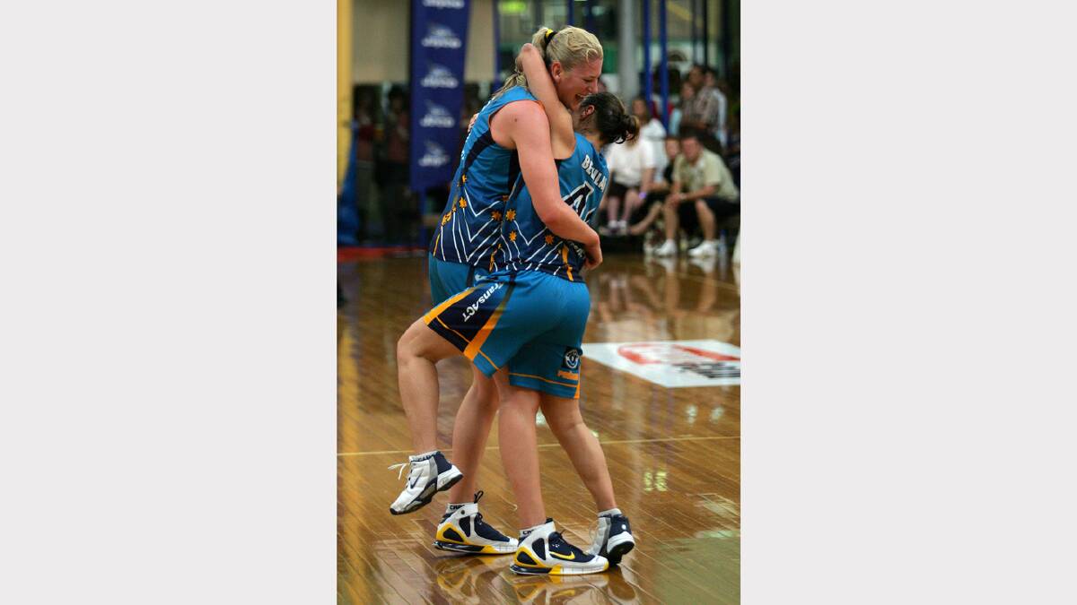 Albury's Lauren Jackson and Tully Bevilaqua of the Canberra Capitals celebrate the 63-55 win over the Dandenong Rangers in the WNBL grand final.