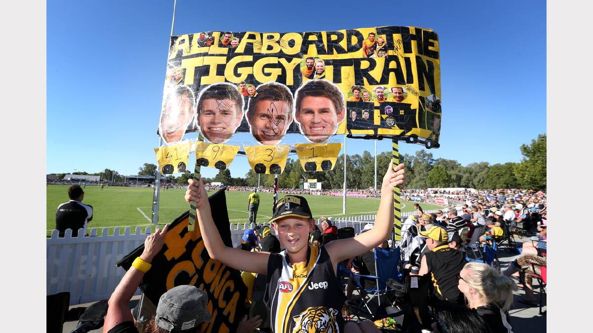Jesse Kelly, 12, of Drouin, made up a sign to support the Tigers at the Norm Minns Oval, Wangaratta.