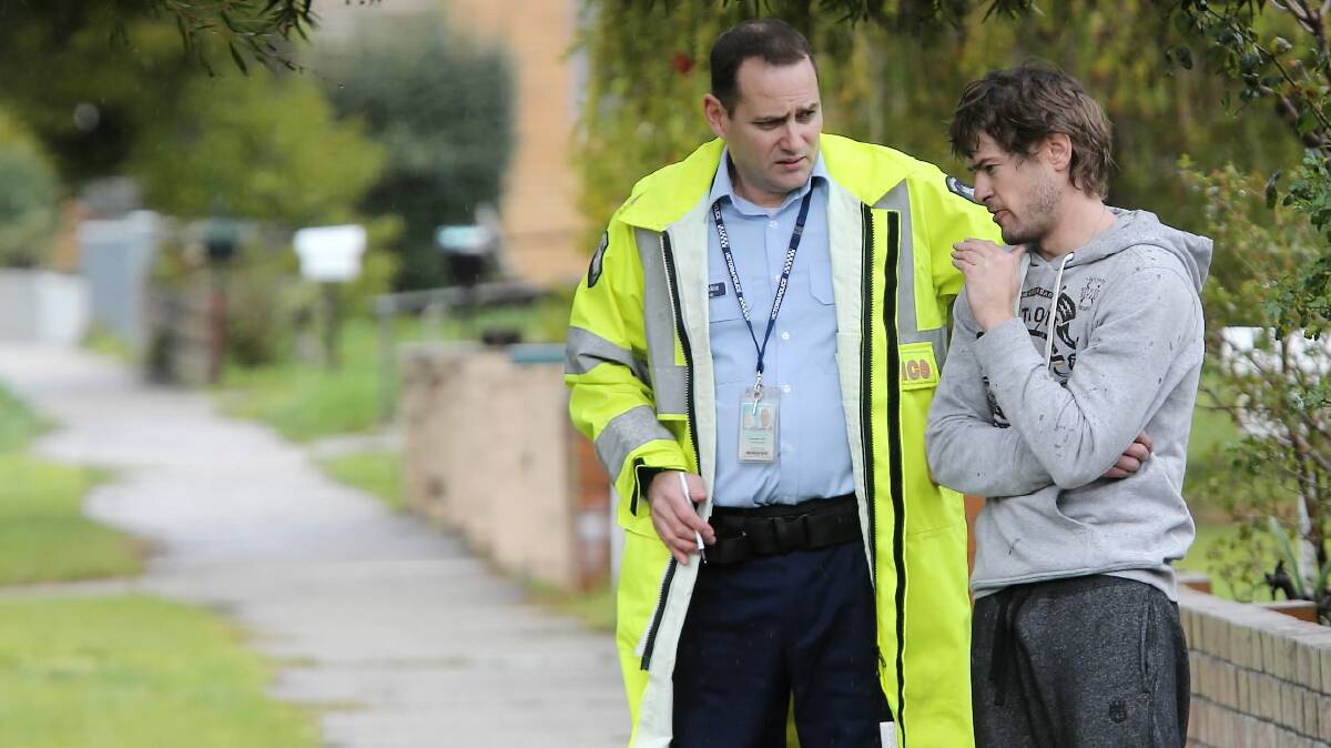 Sen-Constable Troy Bakic talks to Paul Webb after the blaze last year.