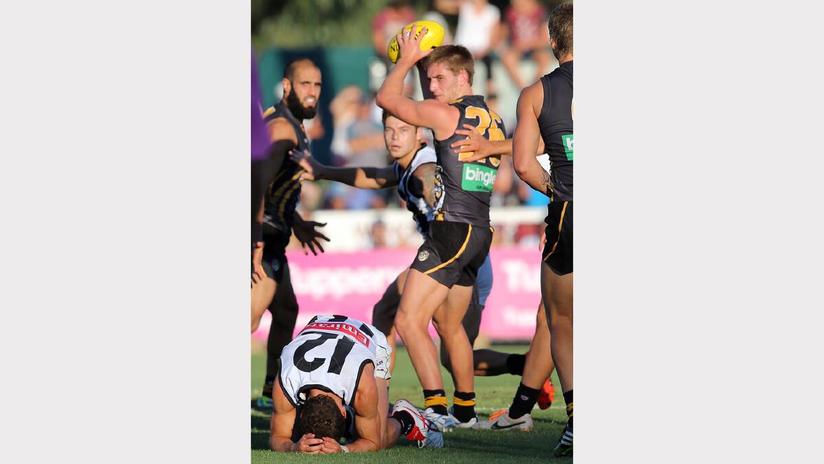 Anthony Miles leaves Collingwood's Luke Ball (12) in his wake as he collects the ball