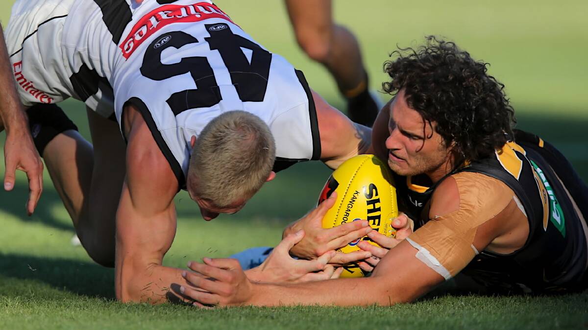 Jack Frost and Tyrone Vickery battle for possession. Picture: FAIRFAX