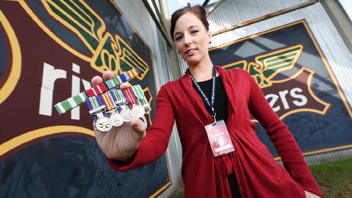 Rivers store employee Emma Rea shows the medals and ribbons strip she found on the floor of her store in Lavington. They show the recipient served in the Vietnam War. Picture: JOHN RUSSELL