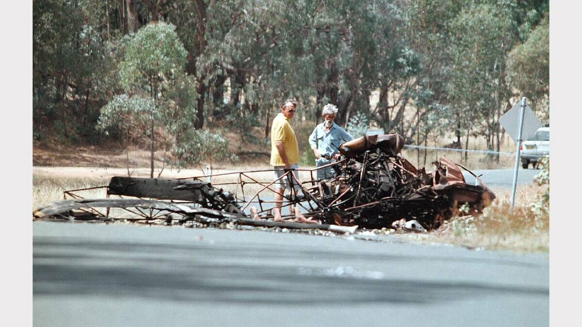 Lankey's Creek, near Holbrook. Fatal helicopter accident in which the pilot, Huw Paffard and his sister, Jaya Paffard died.  The father and uncle of the victims inspect the wreckage. Picture: PETER MERKESTEYN