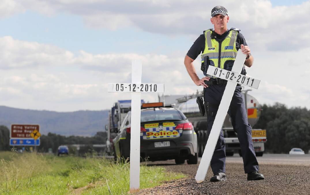 FIFTY kilometres, 12 white crosses, each representing a life lost and a family 
forever shattered. For those driving on the stretch of freeway between Springhurst and Glenrowan over the Easter break, the crosses will be a stark reminder of the 
reality of our road toll. Highway Patrol Sgt Michael Connors, pictured, sought 
approval from police command and VicRoads to line the stretch of freeway with the crosses in a bid to reach out to drivers on one of the country’s busiest roads, at one of its busiest times of year. Picture: JOHN RUSSELL