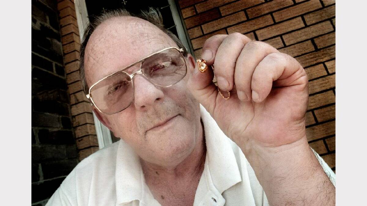 Mr John Ferguson  from Lavington is angered over an international competition scam.  Mr Ferguson holds a diamond and ruby rugby pendant he won through the competition. Picture: KATE GERAGHTY