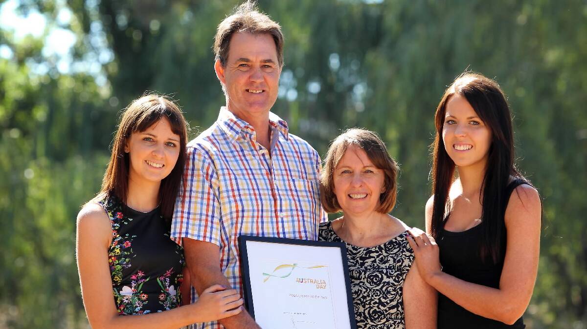 Glenn Mackinnon is congratulated by his family, Jessica, 22, wife Kathy and Sarah, 20, on being named Wodonga’s citizen of the year yesterday. Picture: MATTHEW SMITHWICK