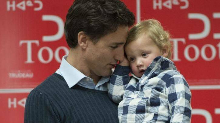 Justin Trudeau holds his son Hadrien during a campaign event in Iqaluit, Nunavut. Photo: Paul Chiasson