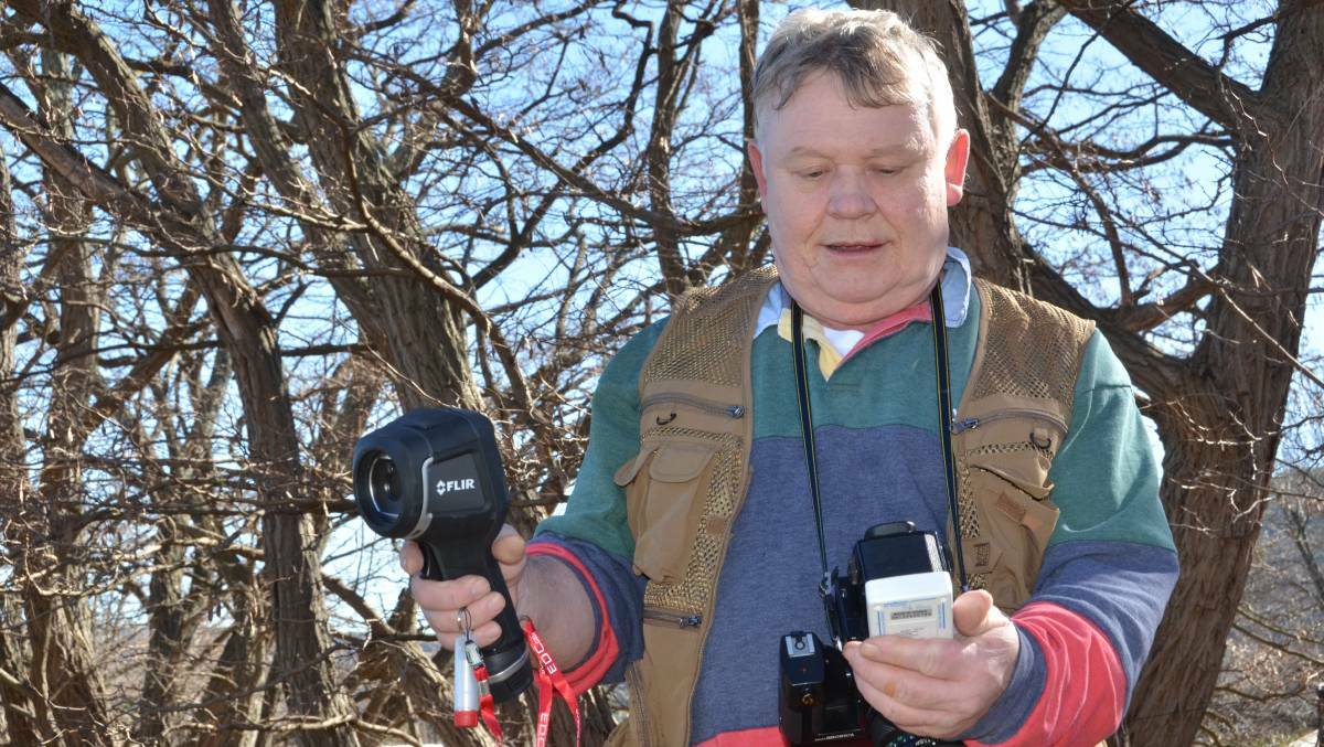 Stephen Barnes with a number of his ghost-hunting devices including a thermal imaging camera. PHOTO: Jacob Gillard.
