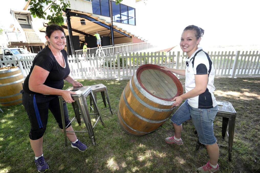 Dewi Streat and Tiffany Bourke-Edwards set up the young members’ area. Picture: PETER MERKESTEYN