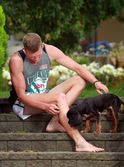 Lavington’s Nick Meredith relaxes at home with his dog yesterday. Picture: DYLAN ROBINSON