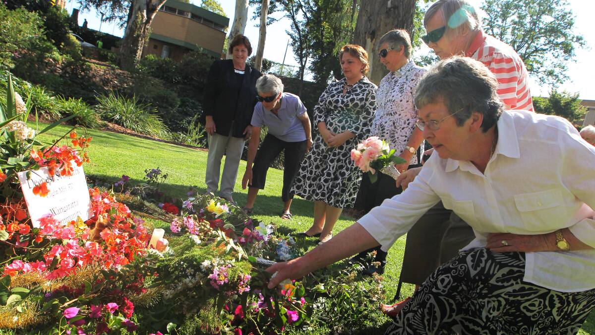 Former member for Indi Sophie Mirabella places flowers on a tribute to the missing passengers from Malaysia Airlines Flight MH370 with Wangaratta residents Beryl Klemm and Allan Wilson. Picture: DYLAN ROBINSON