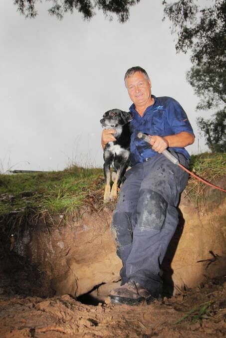 Plumber Gary Tonkin with the rescued dog, Lucky. 