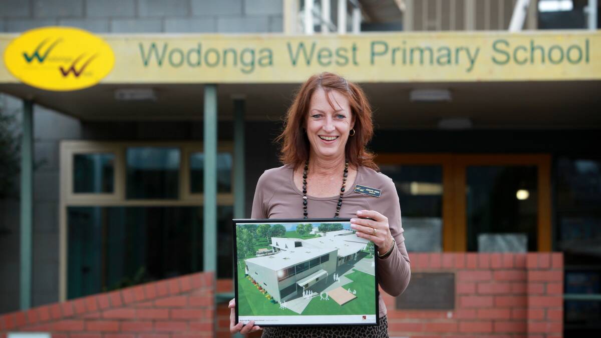 Wodonga West Primary School principal Jocelyn Owen holds an image of what the redeveloped school will look like. Picture: MATTHEW SMITHWICK