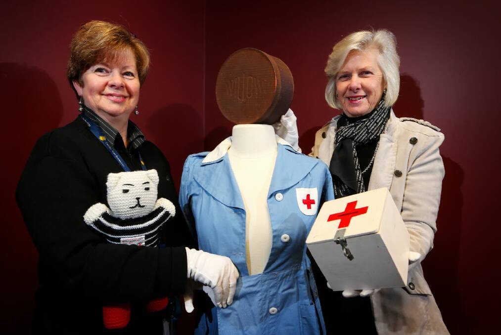 Albury Library Museum collection officer Christine Edgar and Red Cross Zone 20 representative Anne Knox show some of the items to go on display at the Red Cross exhibition. Picture: JOHN RUSSELL