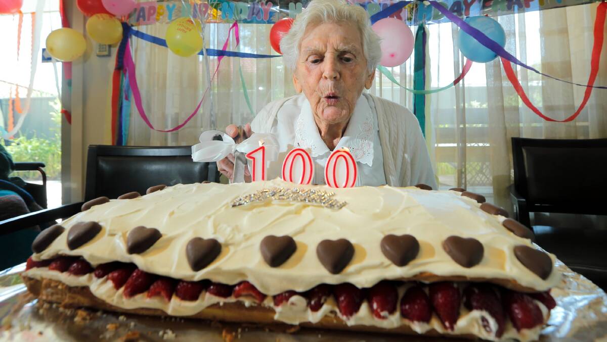 Ida Beard blows out the candles on her 100th birthday cake. Picture: TARA GOONAN