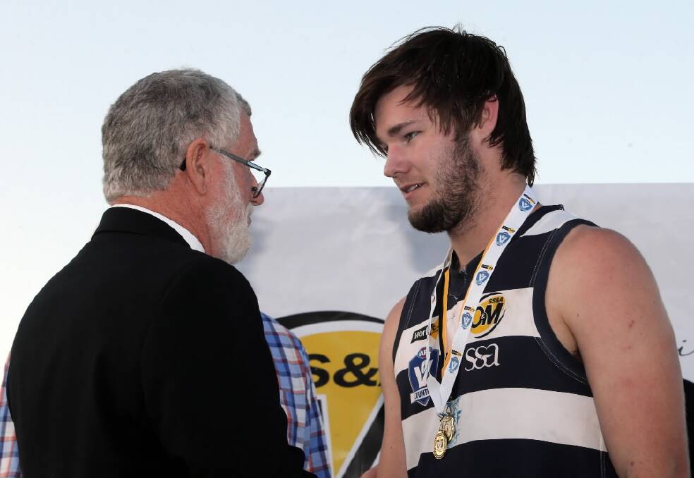 O&M League Chairman Graeme Patterson presents Connor Hargreaves with the Did Simpson Medal. Picture: PETER MERKESTEYN