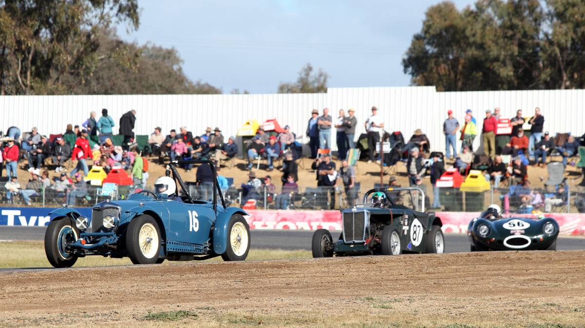 Cars race around the track in the 2012 historic Winton event. 