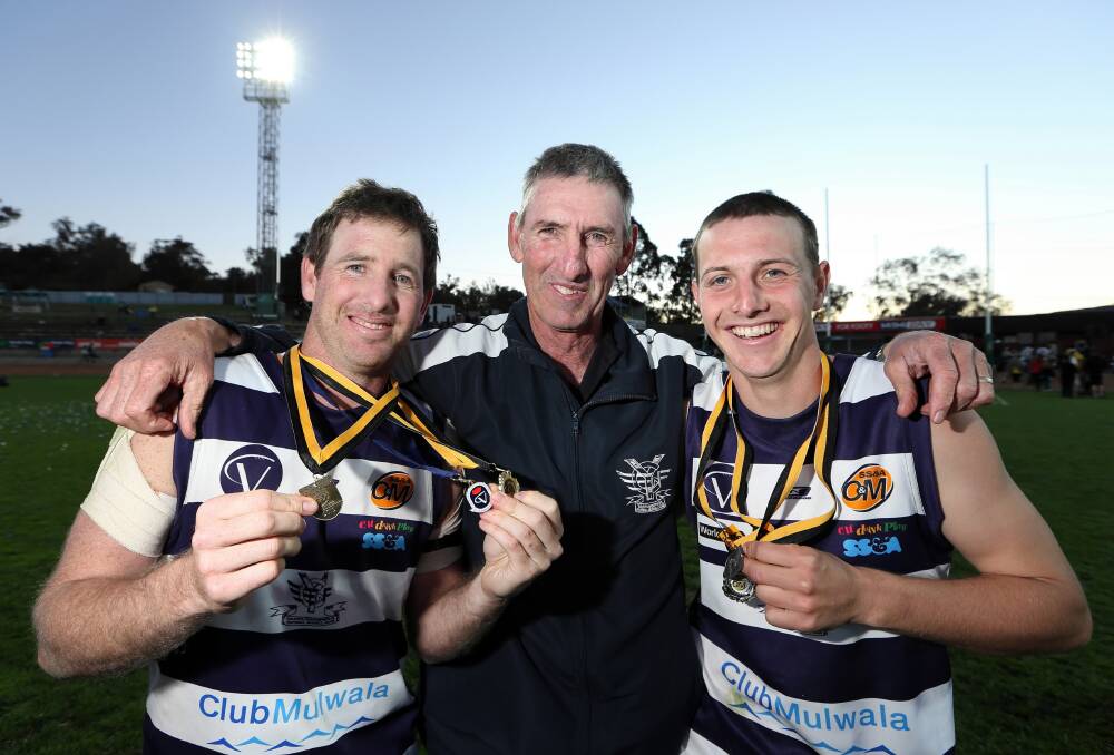 Craig Ednie with his father Russell Ednie and brother Luke Ednie after the Pigeons won the flag in 2012.