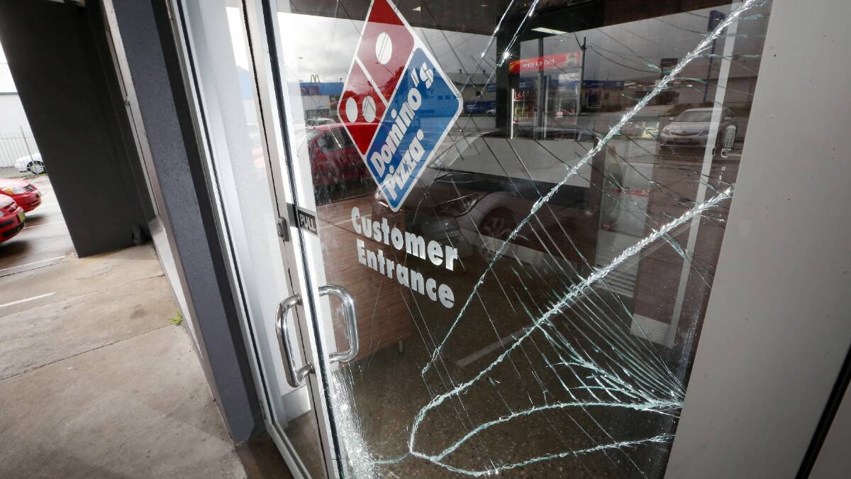 A door that was smashed during the robbery at Domino's Pizza. 