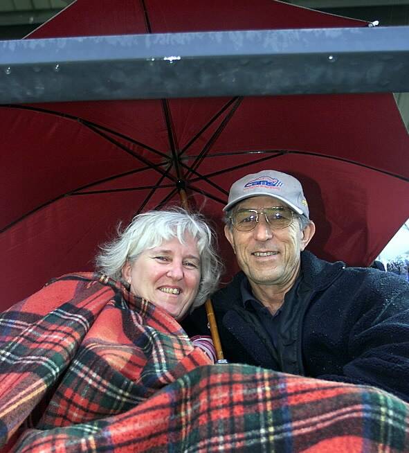 NYE at the Albury Trots - Arthur and Jenny Latta, from Albury, huddle in the  untimely rain. Picture: SIMON GROVES