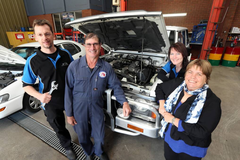 Jenni and Garry Payne (front, in overalls and scarf) are handing Twin City Auto Repairs to Oliver and Andrea Entrop (back). Picture: PETER MERKESTEYN