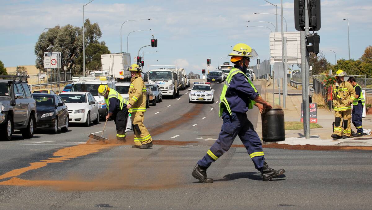Fire crews clean up an oil spill at the same intersection earlier this year. 