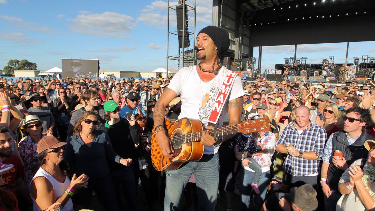 Michael Franti sings to the crowd. 