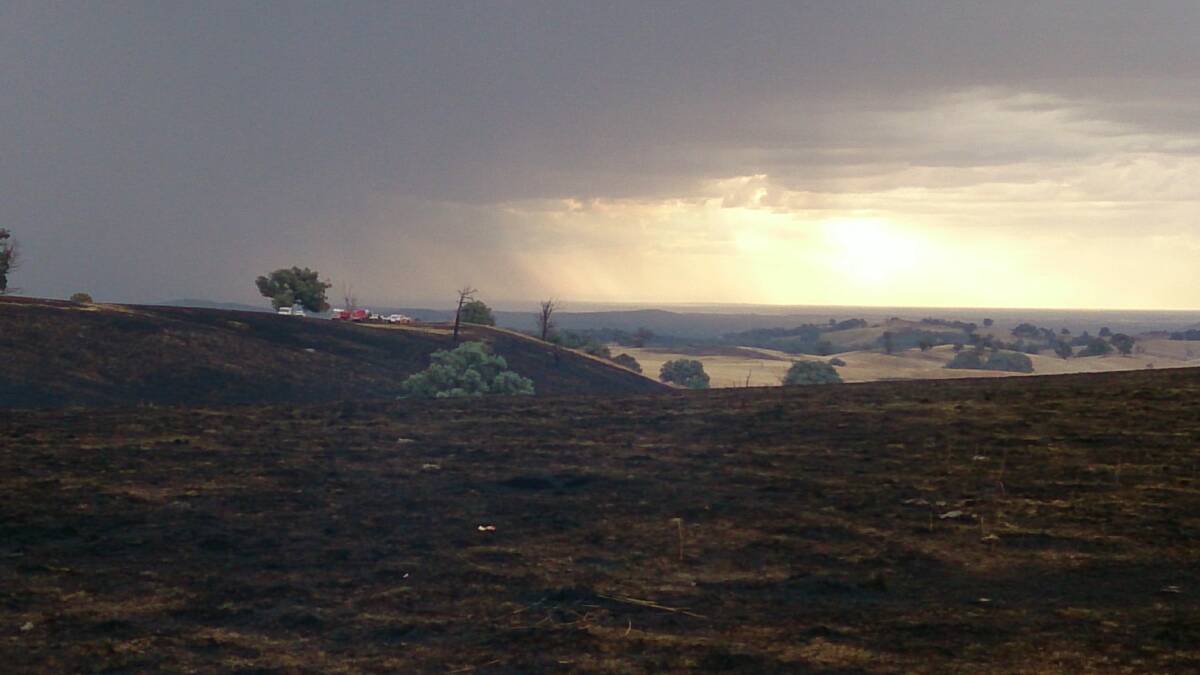 The storm washes over burnt land at Leneva. Picture: Bruce Ray (email)