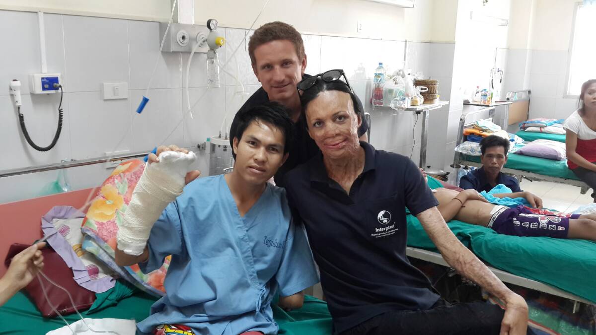 Interplast ambassador Turia Pitt with her husband Michael and a burns victim, Keo, in Laos.