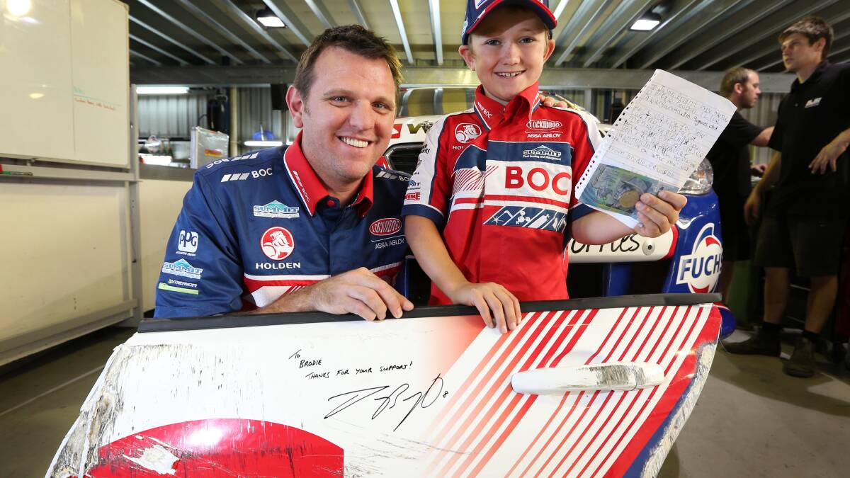 Jason Bright and Brodie Pearson, 9, with his letter and the panel that has been donated to him by the team. 