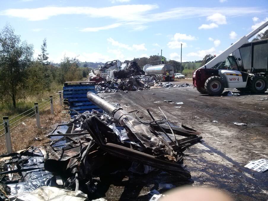 Burnt debris is scattered across the road at the scene of a fatal crash between two heavy vehicles near Woomargama. Picture: SUPPLIED