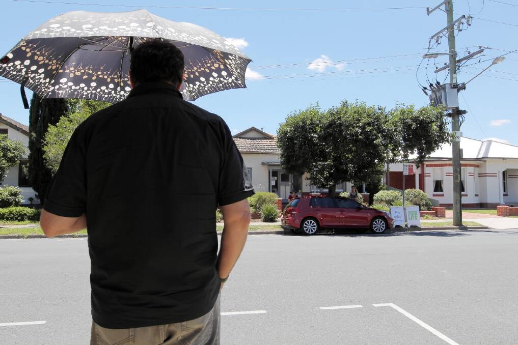 A man prays while standing opposite the Englehardt St abortion clinic.