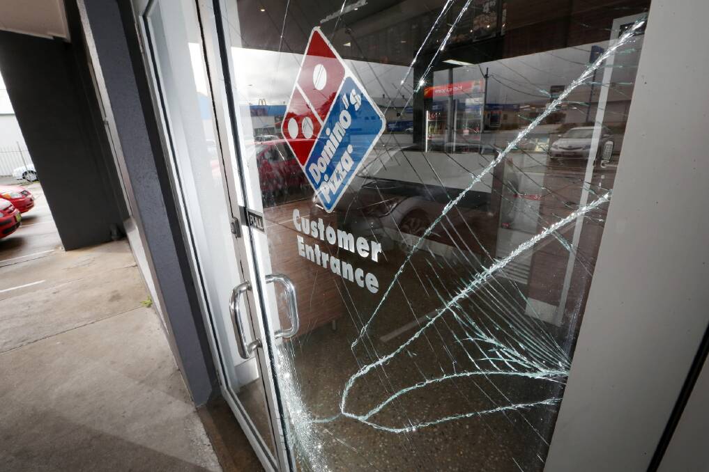 The glass door that was broken when Joshua Cox allegedly robbed the pizza store. 