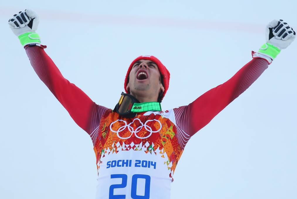 Gold medalist Sandro Viletta of Switzerland celebrates during the flower ceremony for the Alpine Skiing Men's Super Combined Downhill on day 7 of the Sochi 2014 Winter Olympics at Rosa Khutor Alpine Center. Photo by Clive Rose/Getty Images.