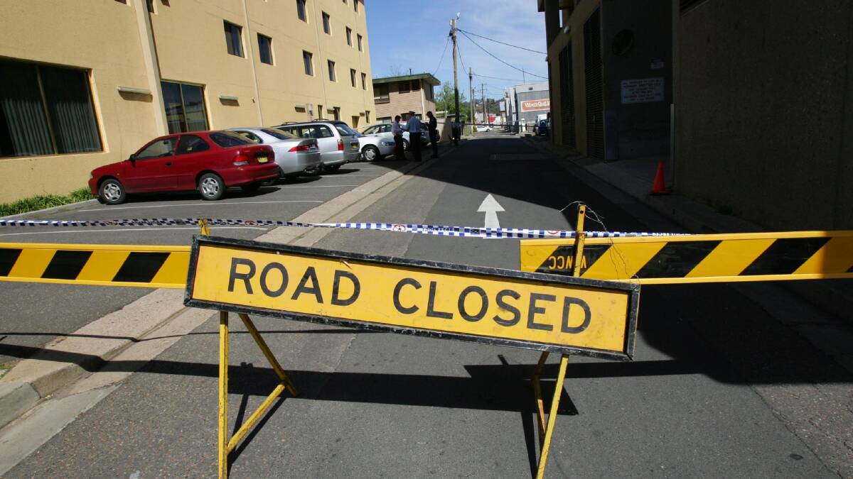 Baretta Lane is closed off by council workers as police establish the crime scene in September 2006. Picture: Les Smith