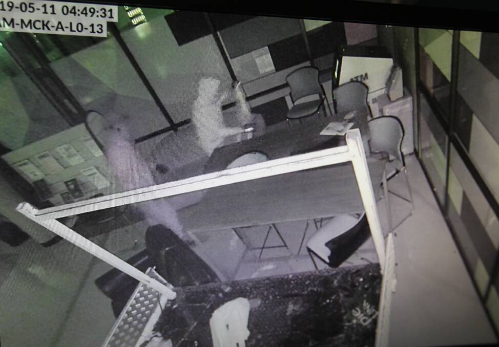 RAMMED: The two men target the ATM at the Wodonga TAFE early Saturday morning, using a stolen light Kia truck. Police are keen to identify the pair in the footage. 