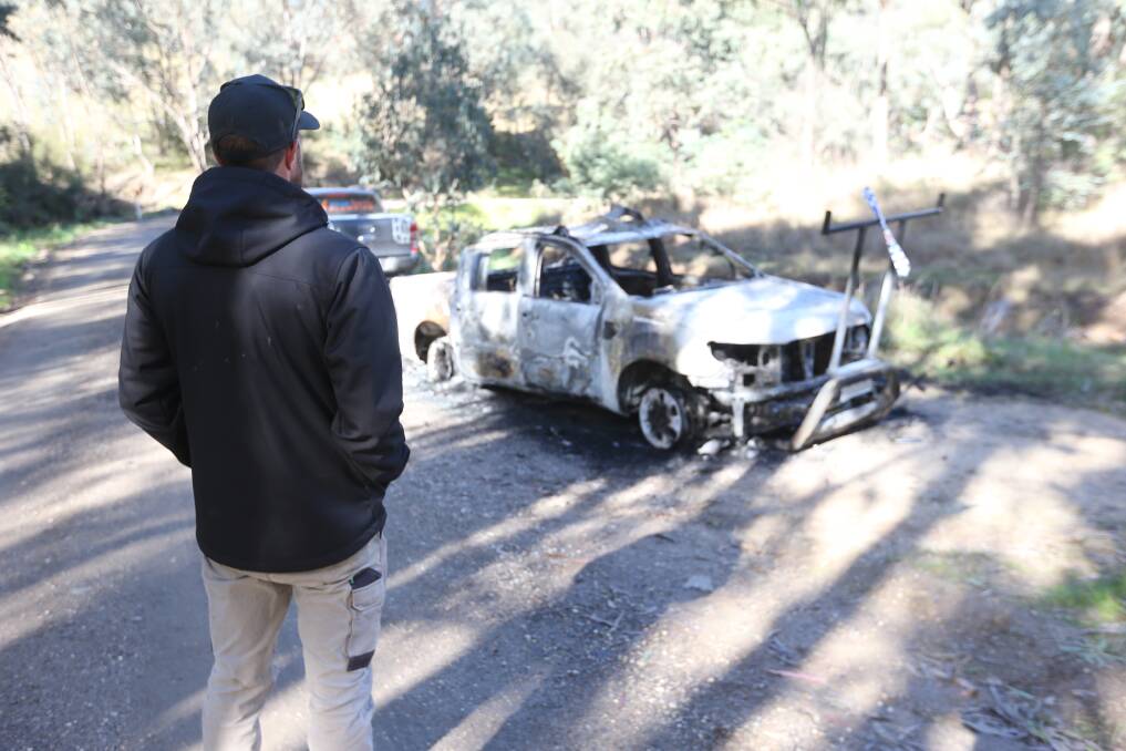 GUTTED: Joel Maskell looks over his burnt out Ford Ranger in a rural part of Prune Street in Springdale Heights on Friday. Pictures: BLAIR THOMSON