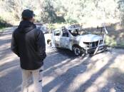 GUTTED: Joel Maskell looks over his burnt out Ford Ranger in a rural part of Prune Street in Springdale Heights on Friday. Pictures: BLAIR THOMSON