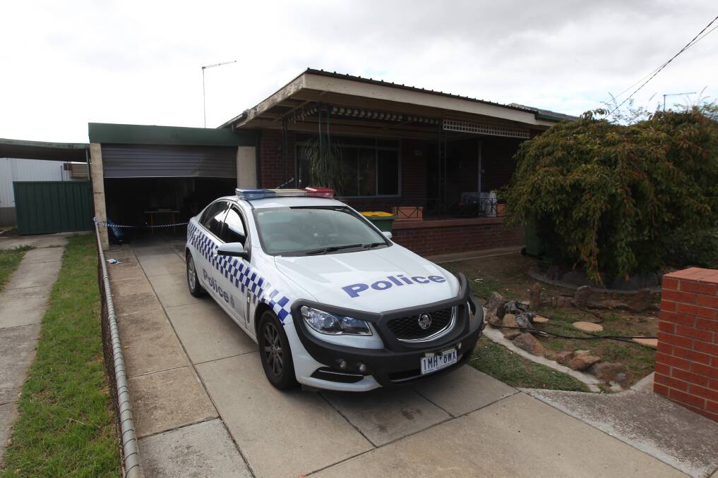 CRIME SCENE: Police guard the Wodonga home on Friday following the blaze a day earlier. The fire caused extensive damage to a shed and pergola. Picture: BLAIR THOMSON