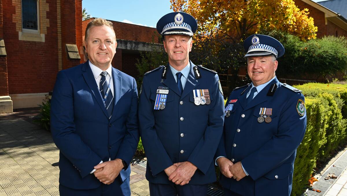 Detective Sergeant Troy Martin, left, and Chief Inspector Scott Russell, right, were recognised by Assistant Commissioner Peter Cotter for their work work raising money for charities. Picture by Mark Jesser