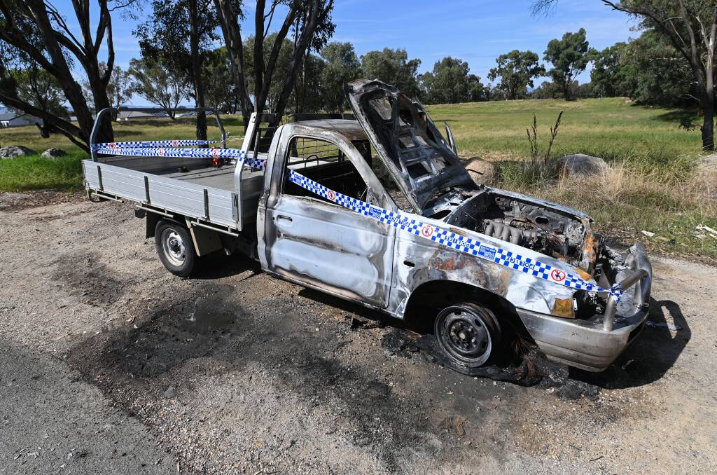 BURNT OUT: Firefighters were called to this burning Victorian registered vehicle at Springdale Heights on Tuesday morning, with police investigating whether the case is linked to a spate of thefts. Pictures: MARK JESSER