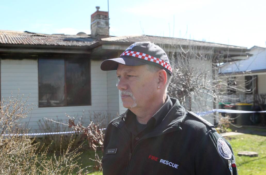 CRIME SCENE: Trevor Logan outside the burnt-out home last week. 