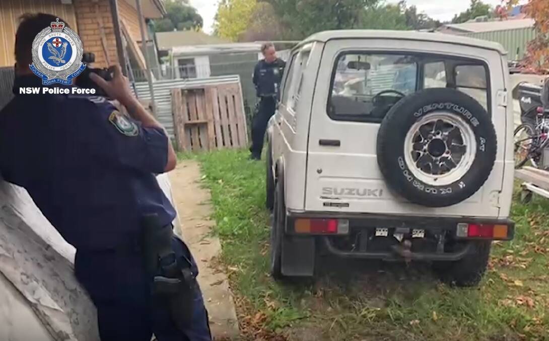 SEIZED: Police examine a Suzuki in Thurgoona last week as part of the investigation. 