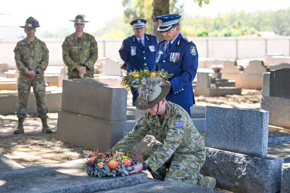 TRIBUTE: Lieutenant Colonel Andrew White, pictured on Monday at Mr Morris' grave in Corowa with police Assistant Commissioner Joe Cassar. Picture: MARK JESSER